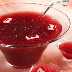 a glass bowl filled with red liquid on top of a table