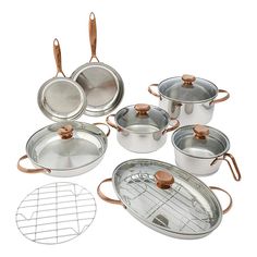 an assortment of pots and pans with copper handles