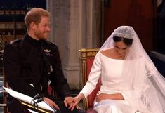 prince harry and his bride are sitting in the carriage