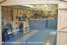 the inside of a wooden garage with tools