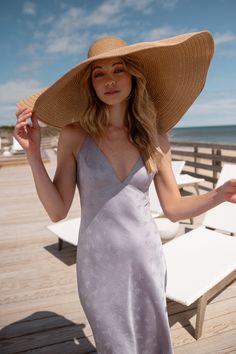 The Jenny Yoo Leilani slip dress is a chic and modern update to the classic slip dress. Featuring a V neck and a delicate spaghetti strap to highlight your shoulders and collarbone. The low scoop back has a barely there feeling, and the bias cut skirt slinks over every curve. A dainty tie at the back adds one last flirtatious detail. Available in Clay Rosette Pink and Oxford Blue. Ready to ship. Shop online now! Spaghetti Strap Lined Midi Dress For Brunch, V-neck Slip Dress With Delicate Straps, Beach Slip Dress With Spaghetti Straps And Built-in Bra, Feminine V-neck Slip Dress With Delicate Straps, Chic V-neck Slip Dress With Delicate Straps, Vacation Dresses With Spaghetti Straps And Built-in Bra, Chic Spring Midi Dress With Low Back, V-neck Slip Dress With Delicate Straps For Wedding, Summer Backless Dress With Built-in Bra And Low Back