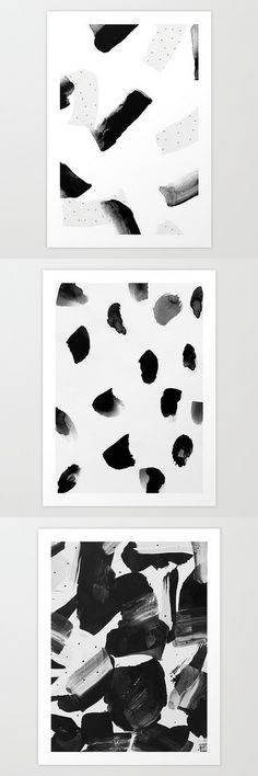 three black and white abstract paintings with different shapes, sizes and colors on the wall