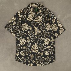 Men's Vintage Tropical Leaf Print Short Sleeve Shirt  + Material: Cotton  + Colour: Black  + Size Label States: Small  + Recommended Size: Small  + Measurements (Inches): Pit To Pit = 19, Body Length = 30  Please note that all vintage items have been previously worn, and may show some signs of previous wear. However, any significant damage will be photographed and/or stated in the items listing. Please note that damage to the inside may not always be photographed or listed. Black Fitted Top With Camp Collar, Fitted Black Hawaiian Shirt With Short Sleeves, Fitted Black Printed Hawaiian Shirt, Black Graphic Print Short Sleeve Shirt For Vacation, Black Short Sleeve Shirt With Graphic Print For Vacation, Black Collared Cotton Camp Shirt, Black Cotton Short Sleeve Shirt With Camp Collar, Black Cotton Camp Shirt With Camp Collar, Fitted Black Shirt With Camp Collar