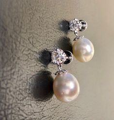 DeKara Designs Collection Metal- 95% Platinum, 5% Iridium. Stones-2 Pear Shape South Sea Pearls 11.3 MM. 2 Old European Cut Round Diamonds G-H Color VS1 Clarity 1.80 Carats, 16 Round Old Mine Cut Diamonds G Color SI1 Clarity 0.04 Carats. Measurement- 1 Inches Long, 0.50 Inch Wide. Handmade Platinum Art Deco Inspired South Sea Pearl Diamond Drop Earrings. There are two beautiful South Sea Pearls dangling right underneath two round Antique Old European Cut Diamonds. There are eight bezel/burnish s Luxury Pear-shaped Earrings With Diamond Accents, Formal White Gold Pear Earrings, Formal White Gold Pear Shaped Earrings, Formal Pear-shaped White Gold Earrings, Formal White Gold Pear-shaped Earrings, Luxury Platinum Pearl Earrings For Formal Occasions, Classic White Gold Pearl Earrings, Classic White Gold Pear-shaped Bridal Earrings, Classic Platinum Pearl Earrings For Formal Occasions