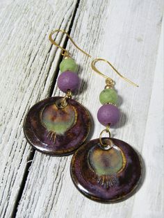 "These are stunning HAND-MADE CERAMIC CHARMS made by an artist in Spain. The charms are 30mm in diameter and LOVE the colors: from BROWN to PURPLE to GREEN to GOLD. These are combined with 10mm matte purple rounds and 6mm matte olive green rounds. Brass finding and spacers and gold-plate ear wires. They are roughly 3\" long with a 2..\" drop. Absolutely DELICIOUS colors and truly one of a kind! Just one pair." Adjustable Drop Earrings With Artistic Design, Artisan Earrings With Artistic Design, Artisan Round Earrings With Artistic Design, Green Earrings For Jewelry Making, Artsy Matching Drop Earrings Jewelry, Artsy Purple Jewelry For Gifts, Artistic Round Beads Earrings As A Gift, Artistic Round Bead Earrings For Gifts, Artsy Teardrop Jewelry With Matching Earrings