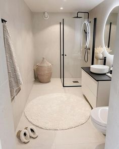 a bathroom with a rug, sink and toilet