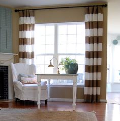 a living room filled with furniture and a fire place in front of a large window