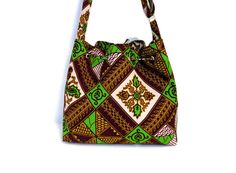 This beautiful 100% cotton African Print Bag is handmade with 100% cotton fabric, lining, and fusible fleece to give it a bit of a sturdy body. This bag can be used as a crossbody bag for women and also for teenagers to take to school. The size is perfect to use daily. All my bags and skirts are made in my pet-free and smoke-free home in Oxford Mississippi. MEASUREMENT: 12'' wide x 11.5'' height x 4 '' deep (gusset). FEATURES: *It has 2 slide pockets and 1 zipped pocket inside. *Closes with a dr Rectangular Cotton Shoulder Bag Perfect As A Gift, Rectangular Cotton Shoulder Bag Gift, Cotton Shoulder Bag With Adjustable Strap As Gift, Casual Fabric Shoulder Bag As Gift, Cotton Bag With Adjustable Strap As Gift, Cotton Canvas Bag With Adjustable Strap As Gift, Green Canvas Shoulder Bag Gift, Square Cotton Shoulder Bag As Gift, Fabric Shoulder Bag Suitable For Gifts