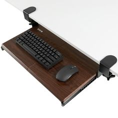 a computer keyboard and mouse sitting on top of a desk