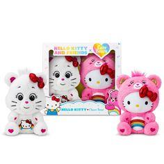 two hello kitty stuffed animals in front of a box