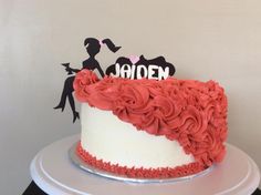 a white and red cake sitting on top of a table