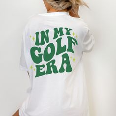 Looking for a cute golf gift? So glad our 'in my golf era' golf tshirt caught your eye! These make the perfect gift for your favorite golfer (or for yourself, of course!) SIZING: These are unisex shirts and run slightly larger/longer for women. Please review the size guide in listing photos for specific sizing information. To achieve the oversized look pictured, size up 1-2 depending on the look you're going for; again, please reference the size chart in the listing photos, as I am unable to offer size exchanges. Bella + Canvas 3001 Unisex tee 100% cotton (solid colors) Heathered colors are a cotton/polyester mix which makes for an extra soft feel. *Please note all of our items are individually made with love for each of our special buyers, and therefore I am unable to offer cancellations, Girl Golf Outfit, Golf Tshirt, Cute Golf, Trendy Golf, Golf Clothes, Girls Golf, Golf Gift, Golf Apparel, Gifts For Golfers