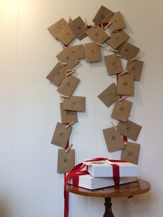 a white box sitting on top of a table next to a red and white ribbon