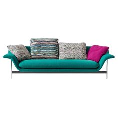 a green couch with colorful pillows on it's back and sides, against a white background