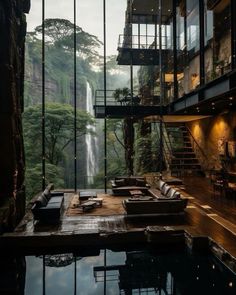 a living room filled with furniture next to a waterfall