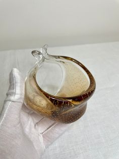 a glass vase sitting on top of a white cloth