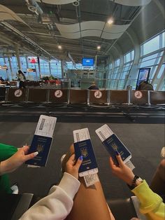 people holding up their passports at an airport