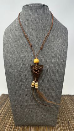 🌎 Handmade Indian-Style Arrowhead Necklace with Coconut Shell Pendant and Brown Feather Accents 🔷 The Beauty of Tradition: Indulge in the beauty of tradition with our exquisite handmade Indian-style necklace. This unique piece channels the spirit of the ancient tribes, crafted to resonate with the timeless aesthetics of indigenous American jewelry.  🌲 Arrowhead Pendant - A Symbol of Strength: The standout feature of this necklace is its arrowhead pendant, a symbol deeply ingrained in Native American culture. This pendant, carefully carved from coconut shell wood, signifies protection, courage, and strength. 🍃 Feathers - Symbols of Honor: Hanging delicately from the arrowhead's bottom point are two brown feathers. In Native American culture, feathers symbolize trust, honor, strength, wi Traditional Natural Color Necklace For Gift, Traditional Brown Jewelry For Gift, Traditional Necklace As A Gift, Traditional Brown Necklace For Gift, Brown Pendant Necklace For Festival, Rustic Handmade Necklaces, Nature-inspired Brown Jewelry For Festivals, Traditional Decorative Necklaces, Traditional Adjustable Decorative Necklaces