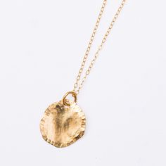 A natural beauty, forever in stone. We love the Lily Pad pendant necklace, an ode to wild hikes and deep dark ponds, rushing falls, water spray in the sunlight, refracting a million rays of sun. An organic, flowing, hand-formed disc of rich 14k yellow gold, threaded on a fine 16" flat cable chain, moves with you on all your adventures. The Lily Pad, fresh and clean and easy to wear everyday, is perfect as a solo piece and incredible stacked with other necklaces, a strata of jewelry, seams of gol Everyday Hammered Medallion Jewelry, Nature-inspired Recycled Gold Jewelry For Gifts, Nature-inspired Recycled Gold Jewelry Gift, Everyday Spiritual Hammered Jewelry, Hand Forged Spiritual Jewelry For Everyday, Hammered Yellow Gold Nature-inspired Jewelry, Spiritual Hammered Round Necklace, Spiritual Hammered Necklace, Nature-inspired Yellow Gold Brass Jewelry