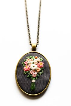 ESTELLE'S HAND EMBROIDERED BOUQUET NECKLACE Nothing brightens a day like flowers do. So here's some flowers you can wear everyday to bring some cheer to your day and outfit. It never wilts plus it's a conversation piece too! I hand embroider every intricate piece, and each pattern is hand drawn so no two necklaces will be exactly the same. This necklace is proudly handmade in the Philippines. - - - - - - - - - - - - - - - - - - - - - - - - - - - - - - - - - - - - - - - - - - - DETAILS: * Pendant Embroidered Bouquet, Hand Embroidered Jewelry, Embroidered Wedding, Embroidery Jewelry, Wife Gift, Statement Pendant, Brass Gold, Gift For Wife, Wedding Bouquet