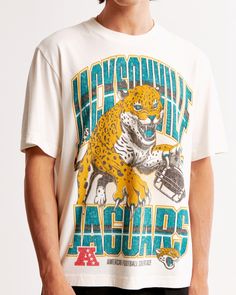 Classic short-sleeve tee in our softAF 180g fabric and vintage oversized-fit silhouette, featuring Jacksonville Jaguars-inspired graphic detail at chest and crew neckline. Male Features, Modern Fan, Men's Tops, Jacksonville Jaguars, Carolina Panthers, Fit Check, Mens Graphic Tee, Team Spirit, Sport Fashion