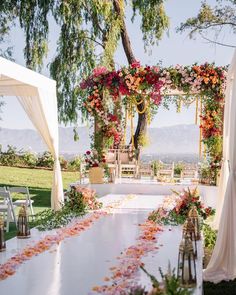 an outdoor wedding setup with flowers on the table