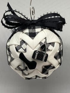 a black and white ornament hanging from a hook