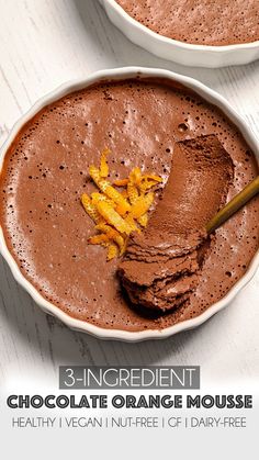 two bowls of chocolate orange mousse with a spoon