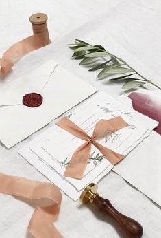 some crafting supplies are laying out on a table with ribbon, scissors and tape