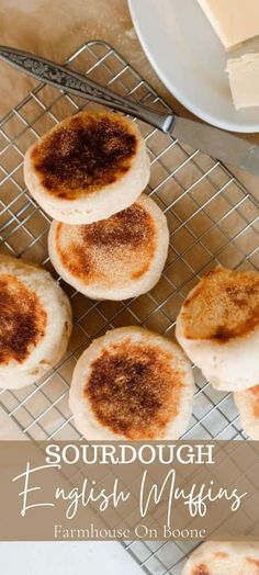 four english muffins on a cooling rack with butter and cinnamon in the background