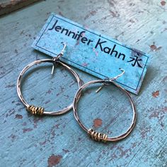 "These thick hammered hoops are a great every day size. Made of 14 gauge sterling wire that I've forged, oxidized and polished to a matte finish. I've added some tiny brass Ethiopian heishi beads for a mixed metal contrast. They hang from sterling earwires. 1 1/2\" diameter (2nd photo, small pair)" Small Hoop Earrings With Oxidized Finish, Small Metal Hoop Earrings With Soldered Detail, Small Hoop Metal Earrings With Soldered Details, Hammered Artisan Hoop Earrings For Everyday, Artisan Hammered Round Hoop Earrings, Artisan Hammered Hoop Earrings For Everyday, Everyday Artisan Hammered Hoop Earrings, Artisan Hammered Hoop Jewelry, Artisan Small Hoop Hand Forged Earrings