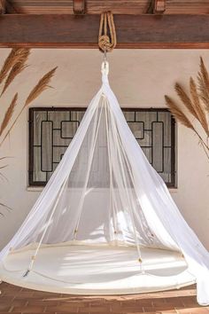 a bed with a mosquito net hanging from the ceiling