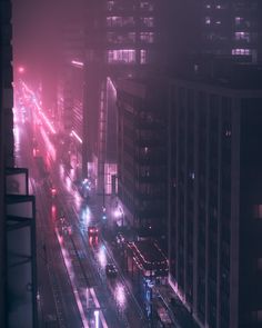 the city street is busy with traffic on a foggy night in the big city