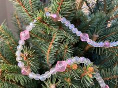 a close up of a pine tree with beads on it