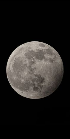 the full moon is seen in this black and white photo, taken from an airplane