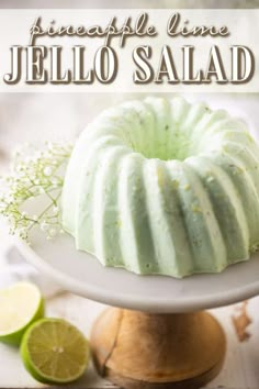 a bundt cake sitting on top of a white plate next to lime wedges