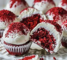 red velvet cupcakes with white frosting and sprinkles on a plate