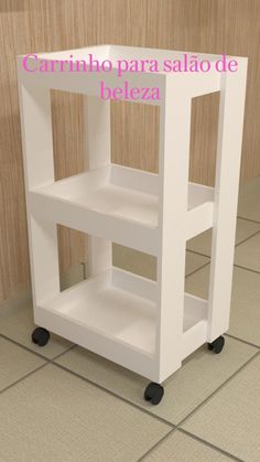 a white kitchen cart sitting on top of a tiled floor