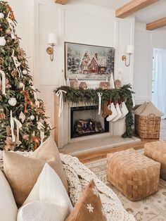 a living room with a christmas tree and stockings on the fireplace mantel, surrounded by holiday decorations