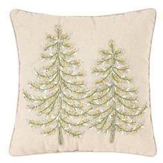 a white pillow with two green trees on it