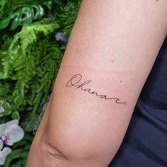 a woman's arm with a tattoo that says, obama on it and the word obama written in cursive font