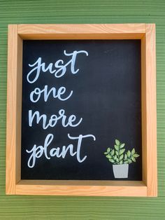 a chalkboard sign that says just one more plant