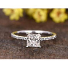 a princess cut diamond ring with pave set shoulders