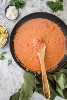 a skillet filled with sauce and pasta