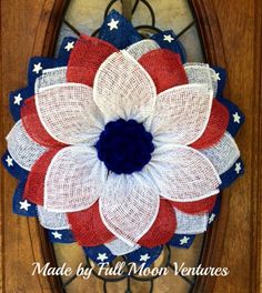 an american flag wreath hanging on the front door