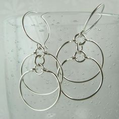 FREE SHIPPING with a purchase of $35 or more! Automatically deducted at checkout~ Crafted of different types of wire, the double circles in this design have a heavier look with lots of movement, yet are still very lightweight. Made of sterling silver, they hang 1-3/4 inches (4.5 cm) in length and the diameter of the circles is about 5/8" (~1.5 cm). Silver Hypoallergenic Open Circle Jewelry, Silver Round Jewelry From Silver Plated Wire, Silver Round Silver-plated Jewelry, Silver Plated Round Jewelry, Modern Wire Wrapped Sterling Silver Earrings, Modern Sterling Silver Wire Wrapped Hoop Earrings, Sterling Silver Open Circle Earrings In Silver, Nickel-free Silver Open Circle Earrings, Modern Silver Wire Wrapped Hoop Earrings