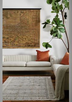 a living room filled with furniture and a large map hanging on the wall above it