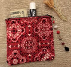 a red and white purse with some items in it