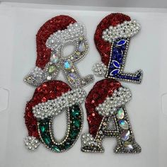 two red, white and blue christmas letters with sequins