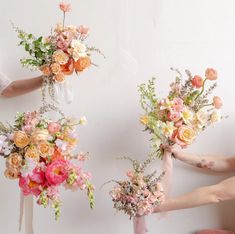 three bouquets of flowers are being held by hands